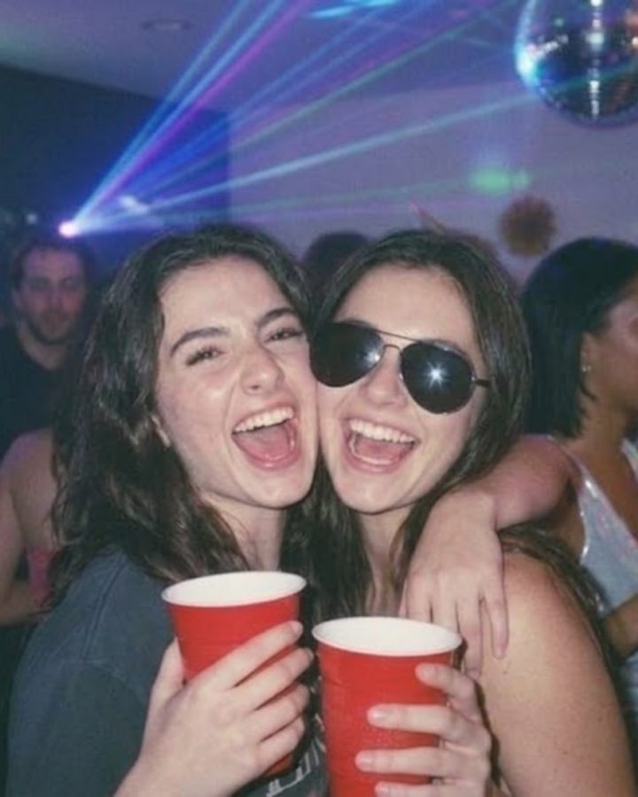 Two friends laughing together on a night out